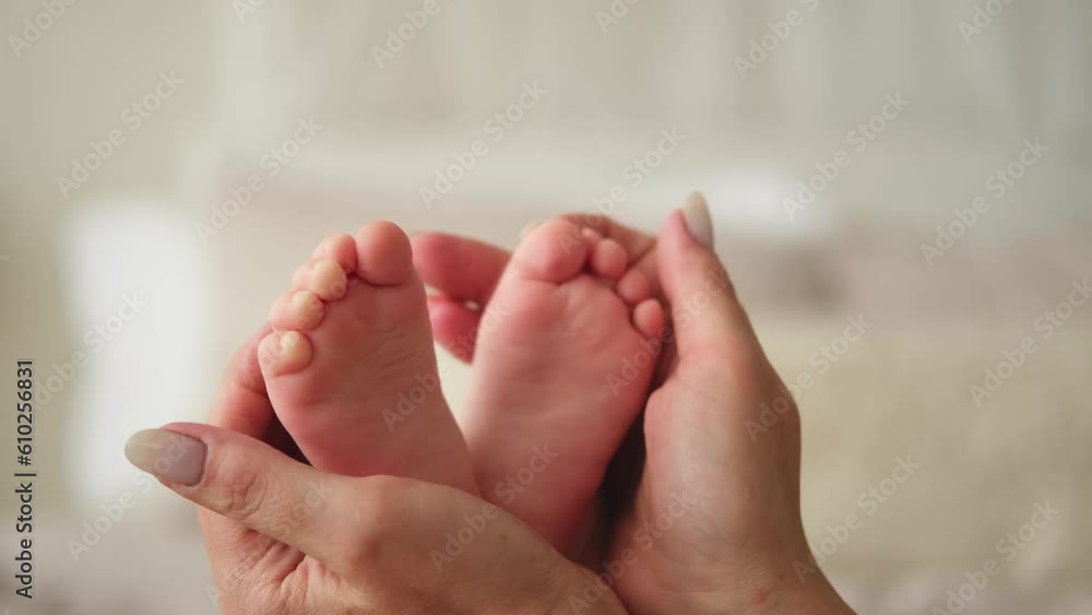 Happy family. Tiny newborn infant male or female baby feet on mother hands. Mother holding newborn child. Mom and her baby. Maternity tenderness parenthood new life concept. Handle with care Happy family. Tiny newborn infant male or female baby feet on mother hands. Mother holding newborn child. Mom and her baby. Maternity tenderness parenthood new life concept. Handle with care