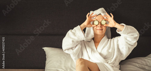 Konstfotografi young woman getting eye nature treatment by cucumber at luxury spa resort