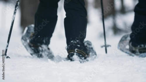 Couple Snowshoeing Outdoor In The Winter Forest Low Angle Closeup photo