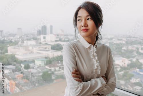 Business asian woman inteupreneur standing by the windows with city veiw. photo