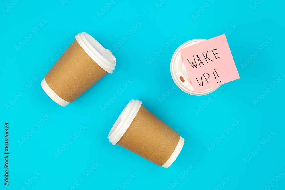 Paper disposable cups and paper reminder with text Wake up. Paper disposable cups and paper reminder with text Wake up.