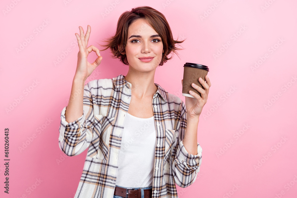 Photo of sweet confident lady wear checkered jacket showing okey gesture drinking coffee to go isolated pink color background Photo of sweet confident lady wear checkered jacket showing okey gesture drinking coffee to go isolated pink color background