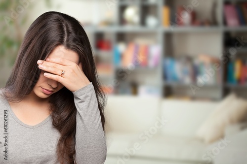 Stressed young person touching head, suffering from headache