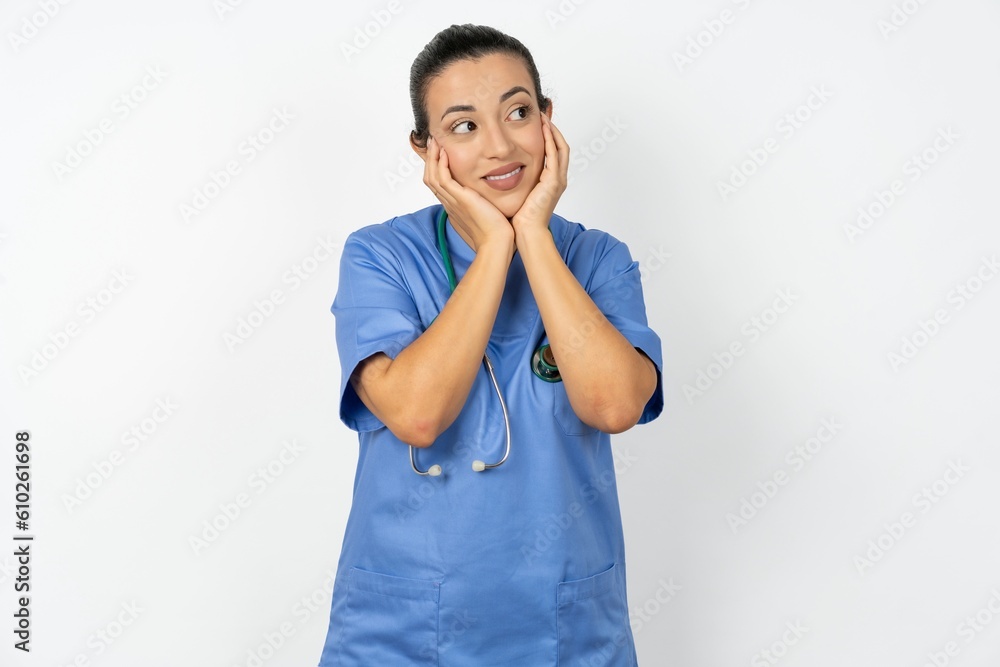 Inspired Beautiful doctor woman standing over white studio background looking at copyspace having thoughts about future events Inspired Beautiful doctor woman standing over white studio background looking at copyspace having thoughts about future events