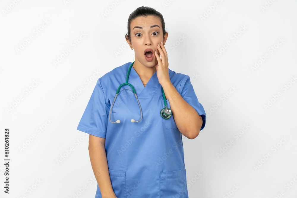 Shocked Beautiful doctor woman standing over white studio background looks with great surprisment being very stunned, astonished with unexpected news, Facial expressions concept. Shocked Beautiful doctor woman standing over white studio background looks with great surprisment being very stunned, astonished with unexpected news, Facial expressions concept.