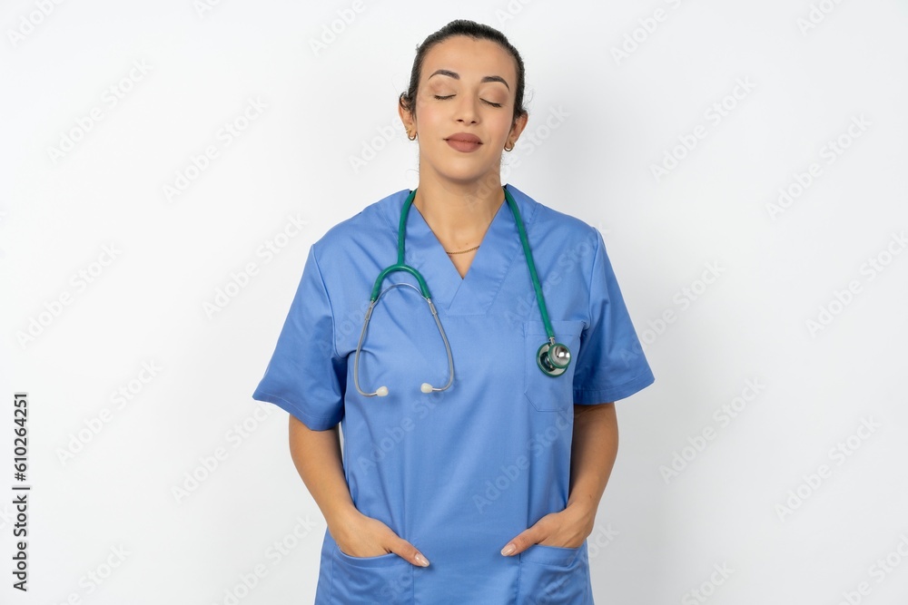 Beautiful doctor woman standing over white studio background nice-looking sweet charming cute attractive lovely winsome sweet peaceful closed eyes Beautiful doctor woman standing over white studio background nice-looking sweet charming cute attractive lovely winsome sweet peaceful closed eyes