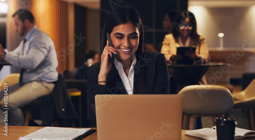 Happy phone call, laptop and professional woman speaking, talk or negotiation with business investment contact. Coworking lounge, night consultant and person consulting, planning or chat on cellphone