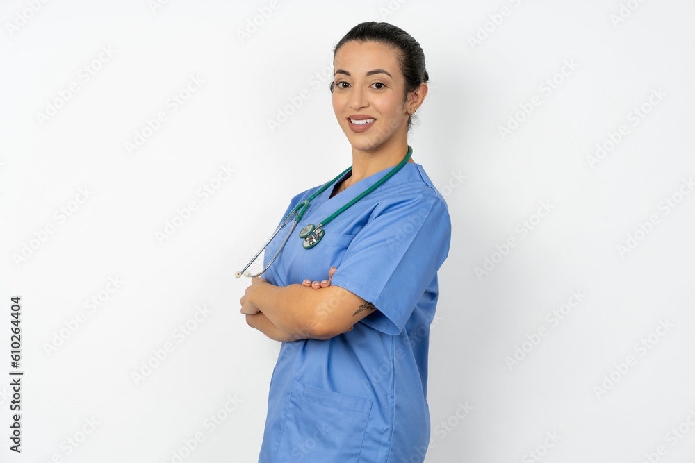 Portrait of Beautiful doctor woman standing over white studio background standing with folded arms and smiling Portrait of Beautiful doctor woman standing over white studio background standing with folded arms and smiling