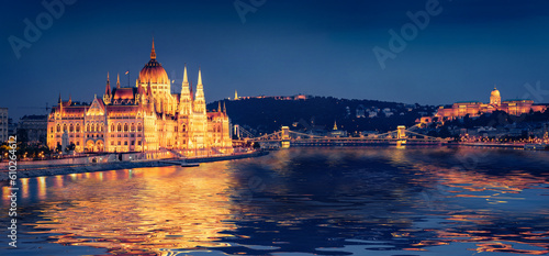 Parliament building and Chain Bridge reflected in the xcalm waters of Danube river. Panoramic summer view of Budapest sity, Hungary, Europe. Traveling concept background..