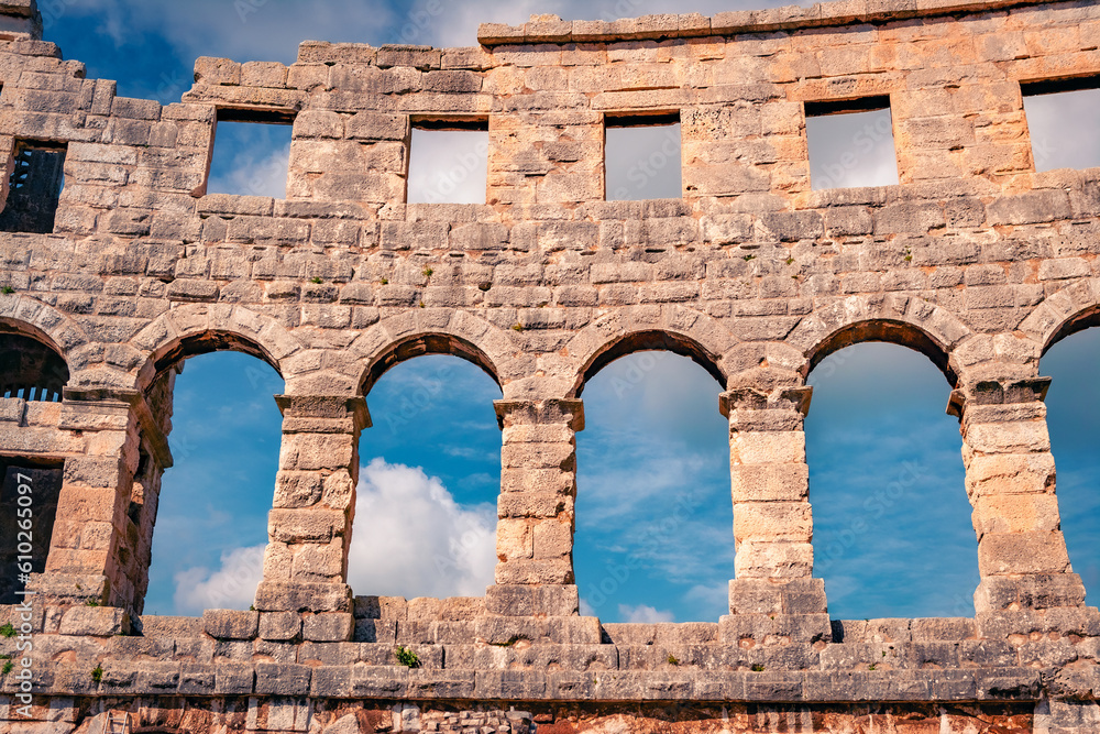 Element of Pula Arena, is known for its ancient Roman structures – notably the Pula Arena amphitheater against blue sky, Croatia, Europe. Architectural background.