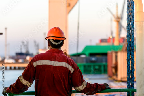 Картината върху платно Seaman in red working overall and orange helmet on deck