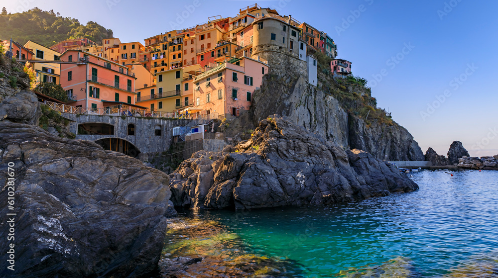 Traditional colorful houses above the Mediterranean Sea in the romantic old town of Manarola in Cinque Terre, Italy in a morning light