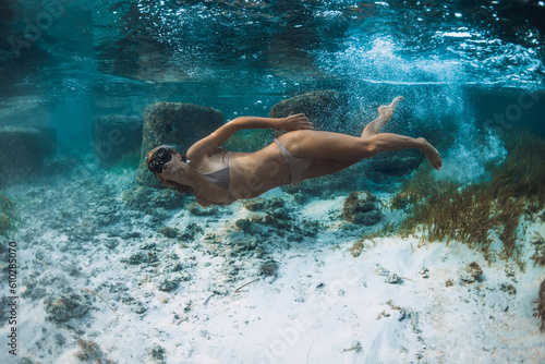 Blonde woman swimming with mask underwater in ocean. Snorkeling in Mauritius or Bali