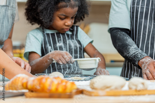 african afro black daughter kids with dad father and mom happy family funny for teach cooking. Black african daughter afro hair and son enjoy with dad preparing the dough, bake cookies in the kitchen