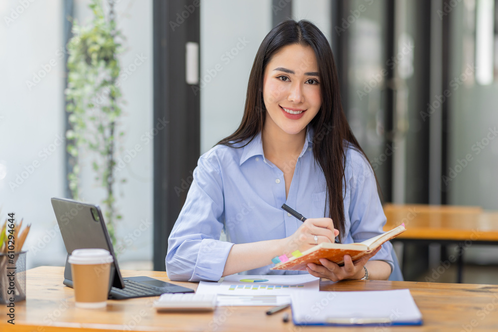 Asian Business woman using calculator and laptop for doing math finance on an office desk, tax, report, accounting, statistics, and analytical research concept
Asian Business woman using calculator and laptop for doing math finance on an office desk, tax, report, accounting, statistics, and analytical research concept