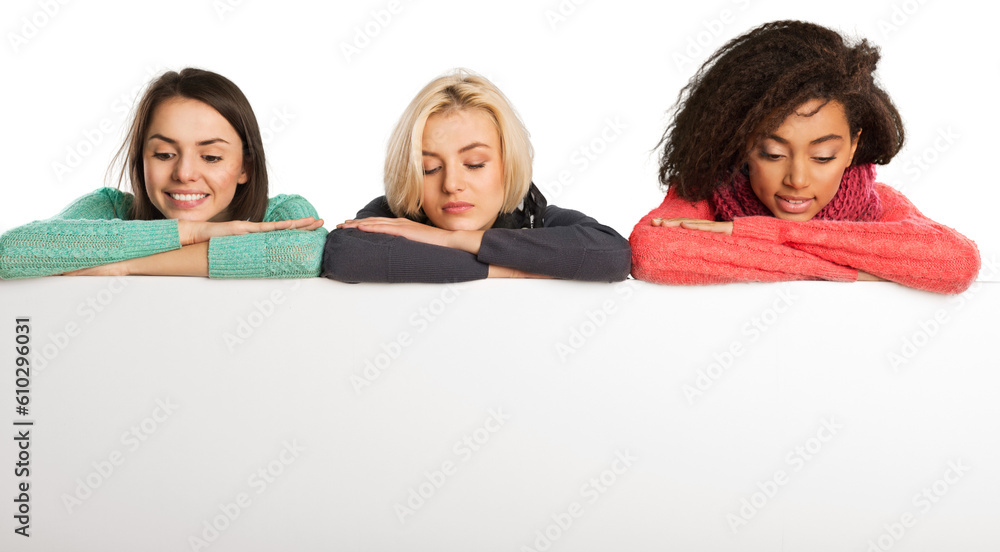 Group of teenagers over the background with the many words from the different languages (language school concept) Group of teenagers over the background with the many words from the different languages (language school concept)