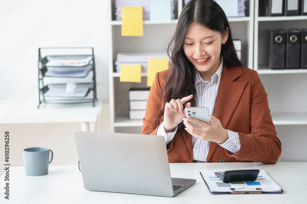 Asian businesswoman talking on the phone working in modern office Chat with clients for a new way of doing business in the office. Asian businesswoman talking on the phone working in modern office Chat with clients for a new way of doing business in the office.