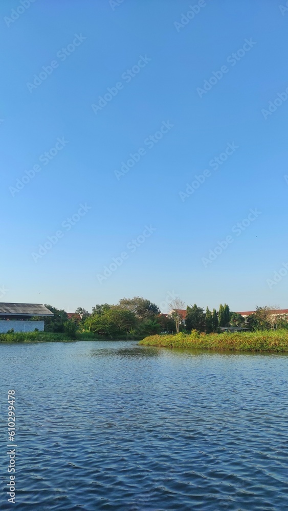 Small island in the middle of lake in the city park during sunny day