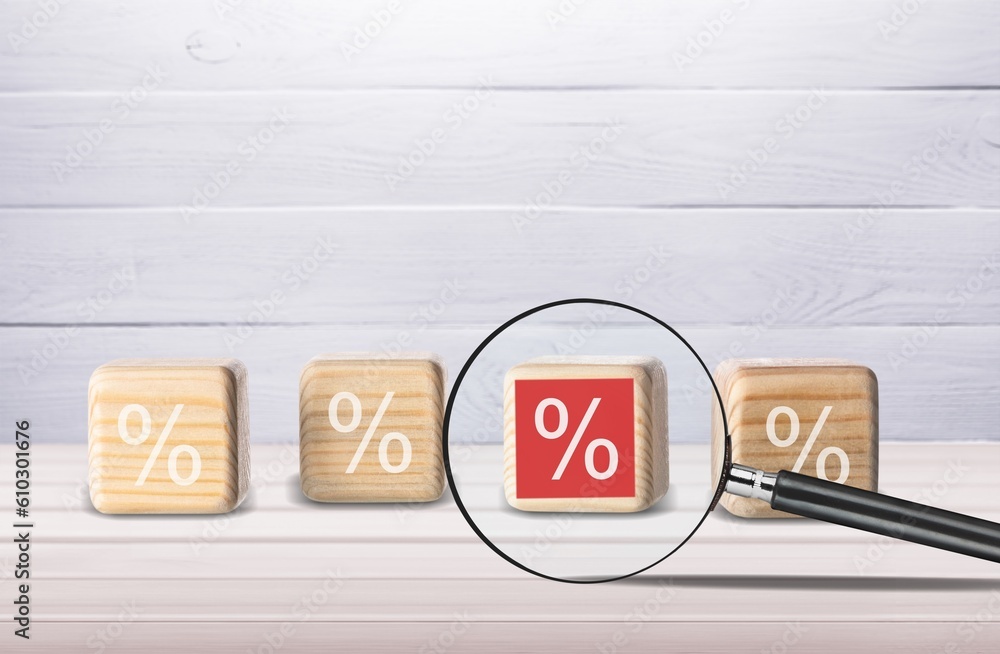 Wooden cube and percent sign on the desk Wooden cube and percent sign on the desk