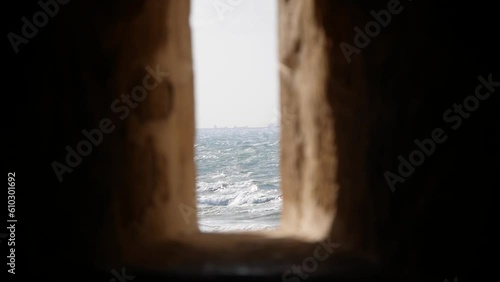 A View of the Sea Through a Narrow Opening in the Stone Wall