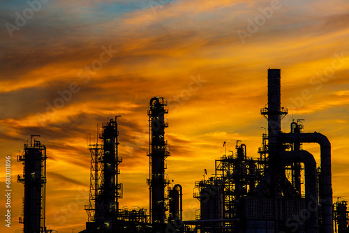 Silhouette of gas distillation of tank oil refinery plant tower oil of Petrochemistry industry on sky sunset