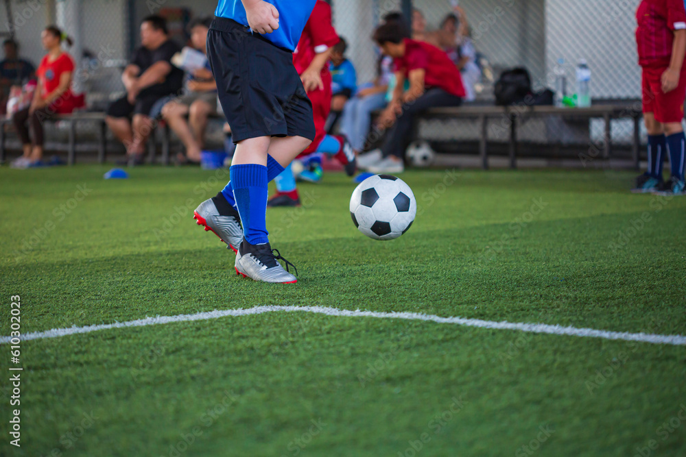 Children playing control soccer ball tactics on grass field with for training Children playing control soccer ball tactics on grass field with for training