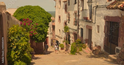 A Couple Is Touring Around The Quaint Village Of Vilafames, Spain. Wide Shot