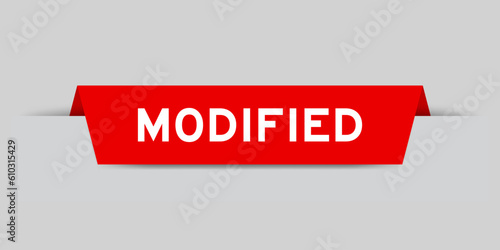 Red color inserted label with word modified on gray background