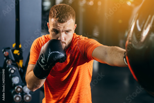 Adult men boxer training in gym photo
