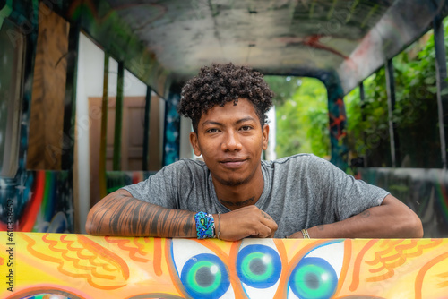 Black boy with afro hair posing for a portrait photograph. Urban photo. person with tattoos