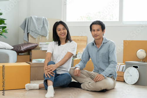 asian couple move into a new house showing a key home