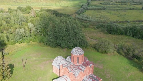 The old Orthodox Church of the Savior on Kovalev on the outskirts of Veliky Novgorod. The view from the drone on a sunny day. photo