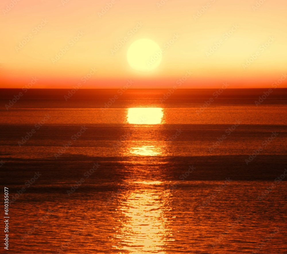 Sun rising over a colorful ocean