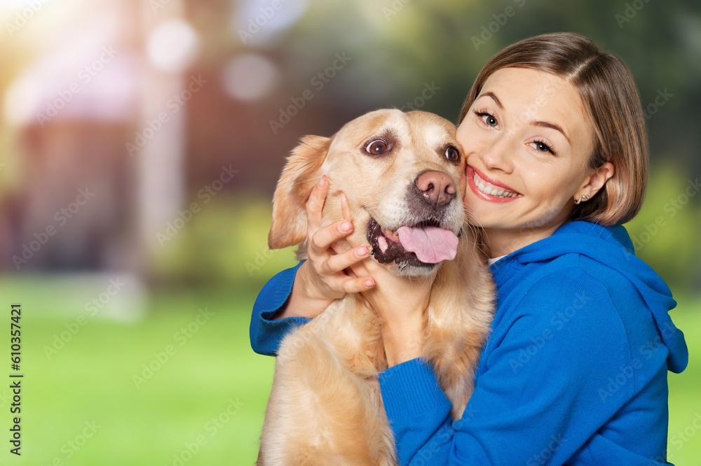 A Portrait of young girl petting cute dog outside