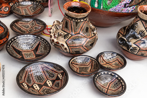 Pottery craft made by Quechua women from the Ecuadorian Amazon region, city Puyo. Small bowls and jug with a traditional design for everyday use and for communal ritual activities. photo