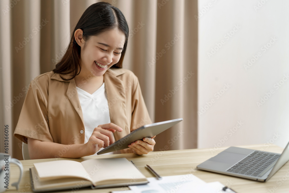 Happy Confident young asian businesswoman working with tablet Start up small business owner. business successful technology concept