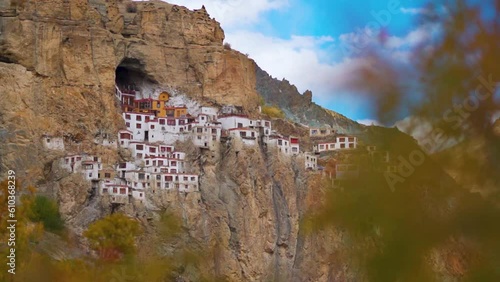 Phugtal Gompa during the autumn season at Zanskar in Ladakh, India. Monastery built on a cave inside the mountains about 2500 years ago. View of monastery inside the mountain in Zanskar at autumn.  photo