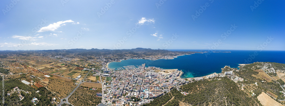 Wide angle large aerial photo of the beautiful town of Sant Antoni de Portmany in Ibiza Spain showing the whole of the town and ocean beach front in the summer time.
