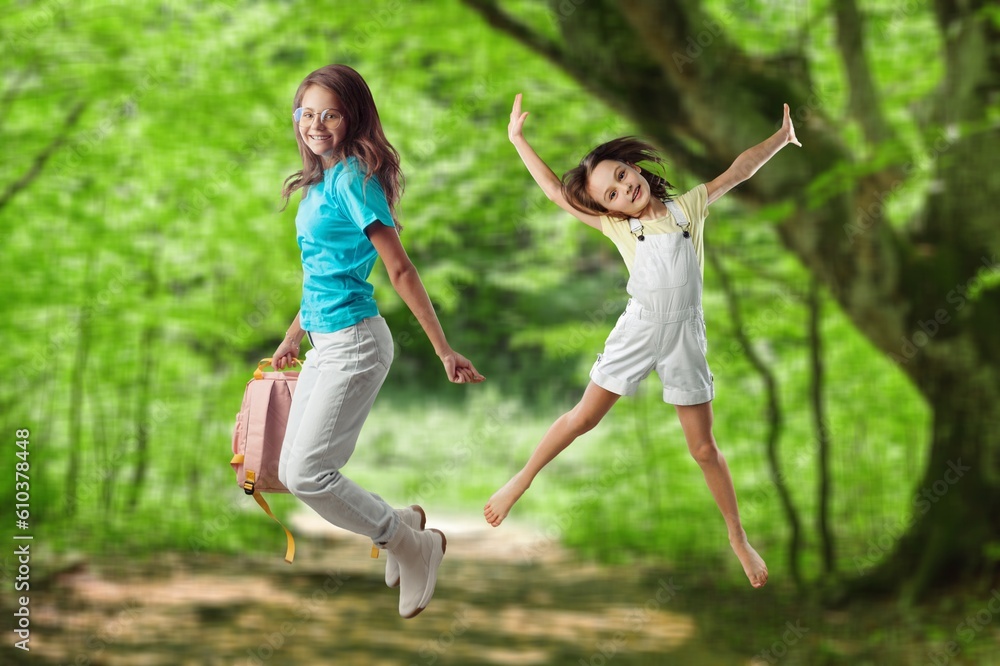 Happy young Children Jumping on forest background Happy young Children Jumping on forest background