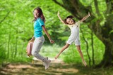 Happy young Children Jumping on forest background