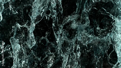 Super slow motion of splashing water surface on black background . Filmed on high speed cinematic camera at 1000 FPS