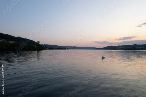 aerial footage of people kayak during sunset in the lake in Switzerland