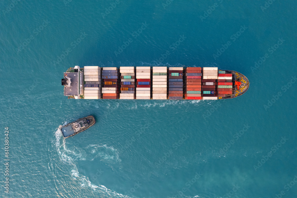 Fototapeta premium Top view Logistics and transportation of Container Cargo ship and Cargo plane with working crane bridge in shipyard at sunrise, logistic import export and transport industry background