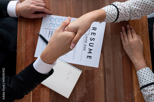 Fotografie Happy business people shake hands after successful meeting or job interview with resume