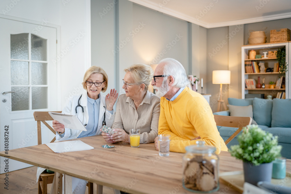 Home visit female doctor with senior man and woman couple at home talk Home visit female doctor with senior man and woman couple at home talk
