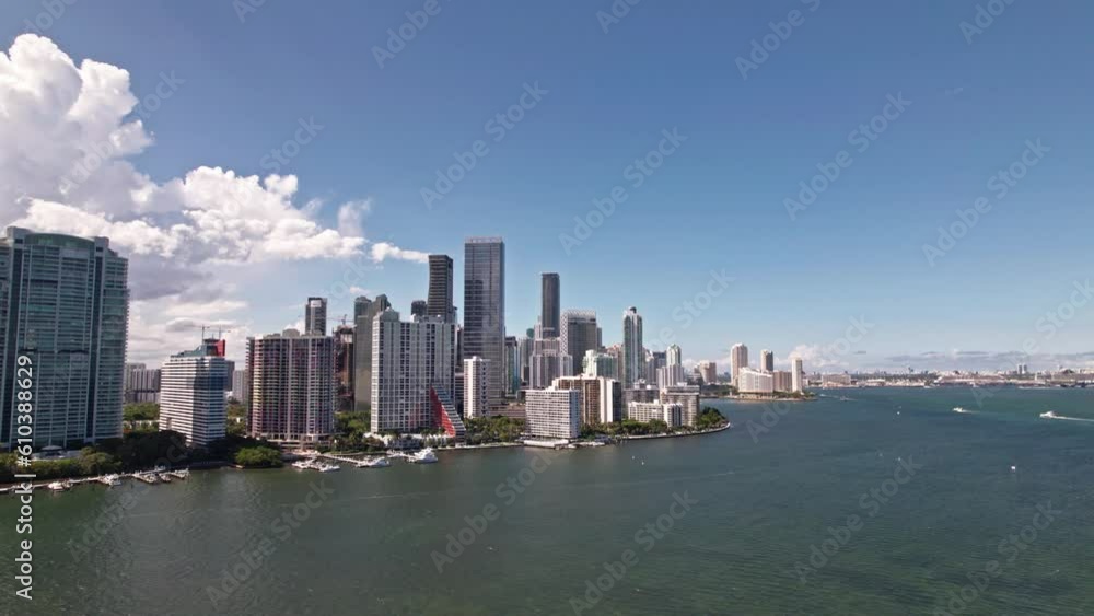 Establishing aerial orbit drone shot of Brickell district Miami Florida. Blue cloudy sky. yachts stay in marina. Skyscrapers and modern buildings. Establishing aerial orbit drone shot of Brickell district Miami Florida. Blue cloudy sky. yachts stay in marina. Skyscrapers and modern buildings.