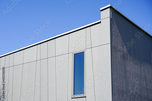 Abstract new modern residential house gray facade fragment against a blue sky