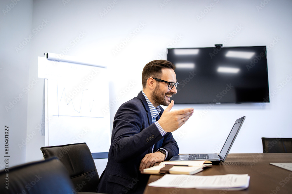 Businessman having a video call on his computer in the office. Businessman having a video call on his computer in the office.