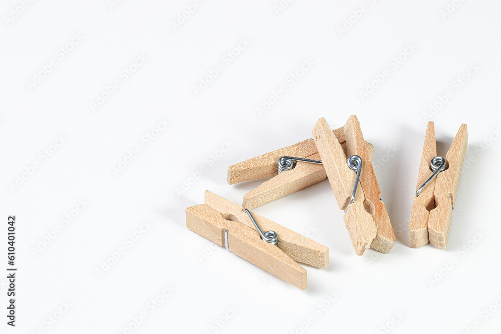 Mini wooden clothespin collection isolated on white background. Clothespins in different positions for household use or decorated.