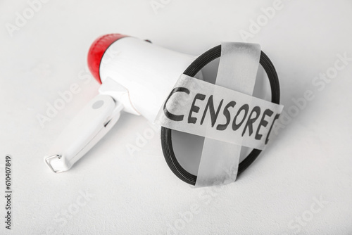 Φωτογραφία Taped megaphone with word CENSORED on white background